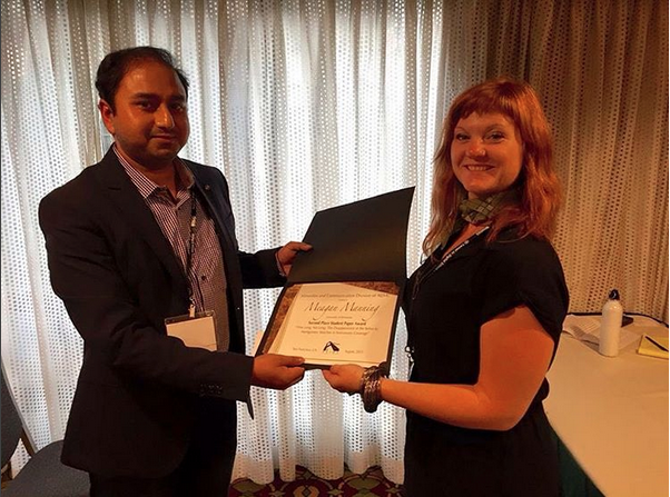 MAC Division's research session moderator Saif Shahin handed over the award to Meagan Manning, author of second-place student paper.