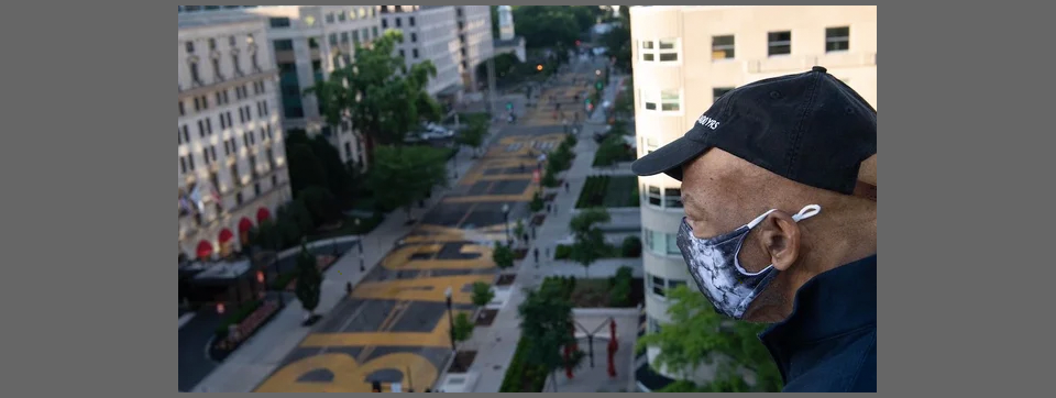 Picture of Congressman and Iconic Civil Rights Leader John Lewis looking over the Black Lives Matter plaza from the top of a building in Washington D.C. in June 2020, almost a month before had passed away